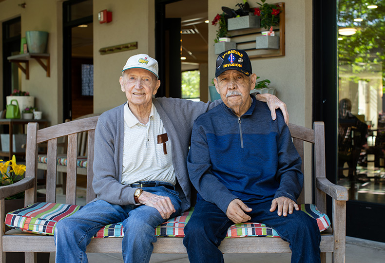 Two friends on a bench in the garden.