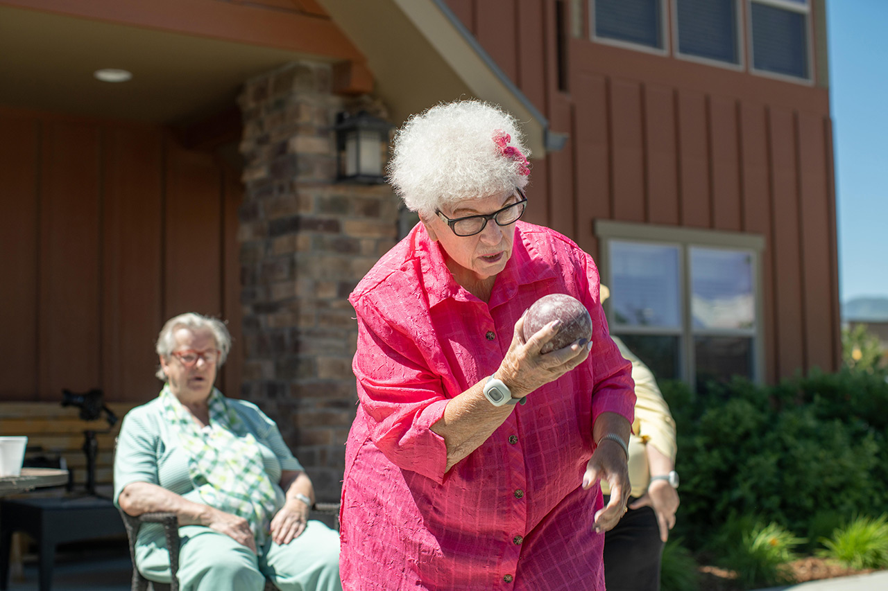 A resident is playing bocce ball.