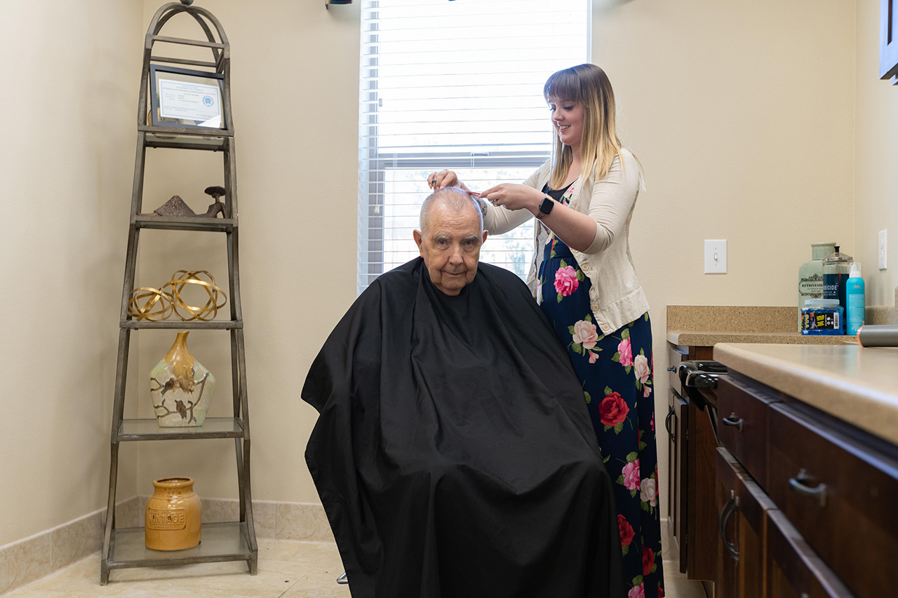 A resident is having their haircut.