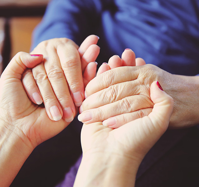 Two people are holding hands.