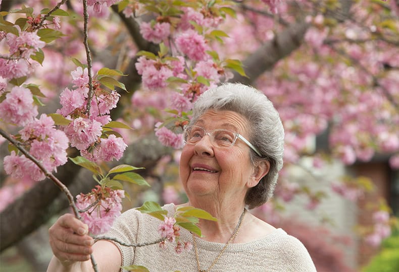 A resident is looking at flowers.
