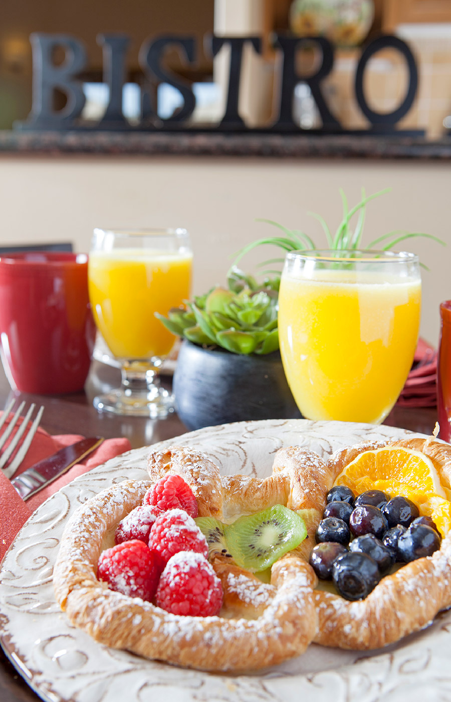 A welcoming breakfast made of fruit pastry and orange juice in champagne glasses