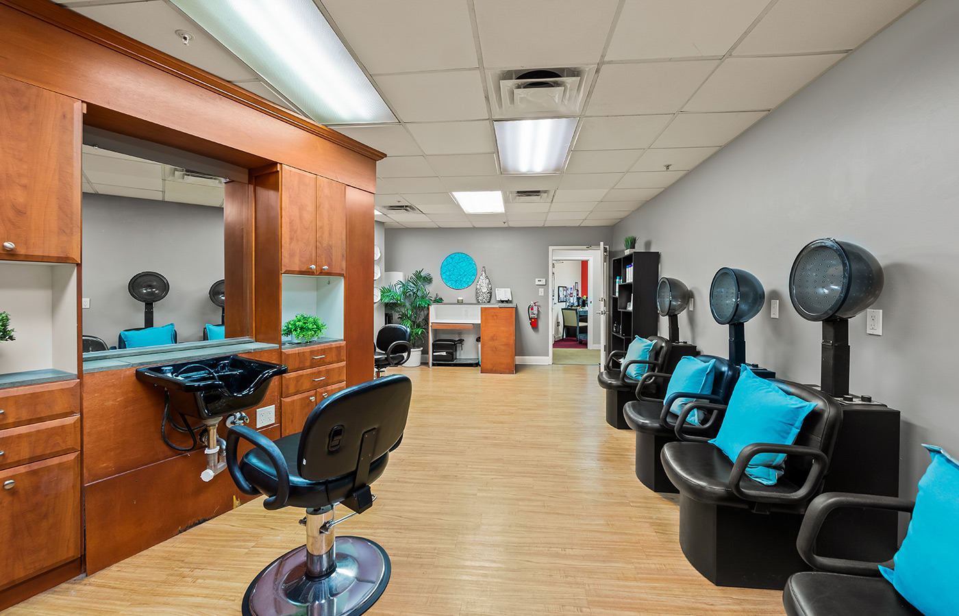 The salon with many stations for styling and drying hair.