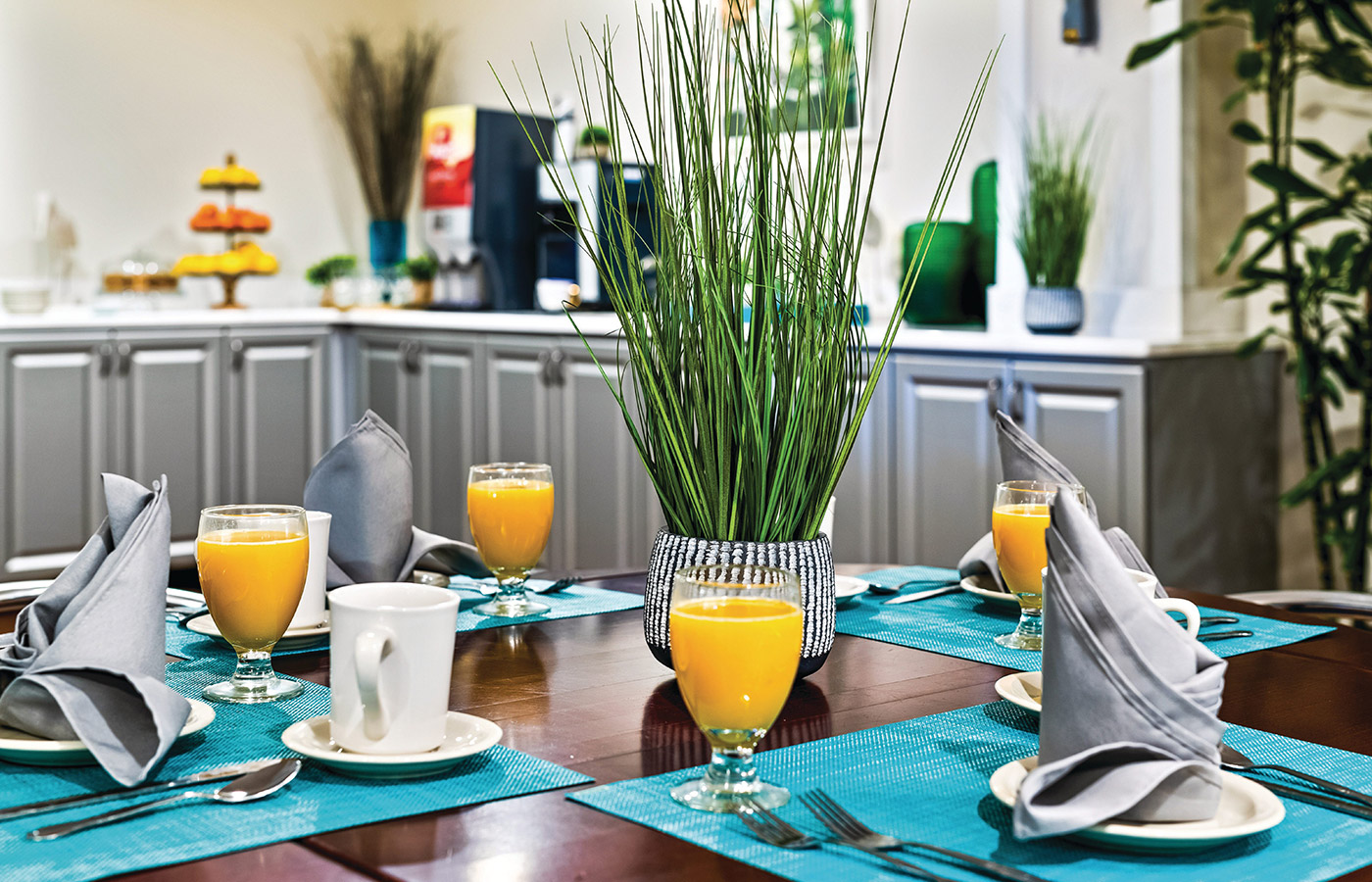 Dining table arranged for breakfast with orange juice in champagne glasses