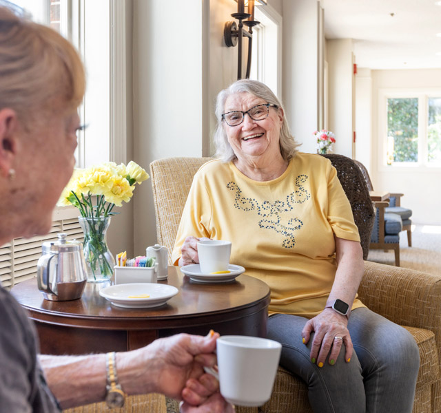 Two residents are having coffee together.