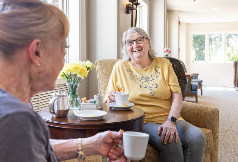 Two residents are having coffee together.