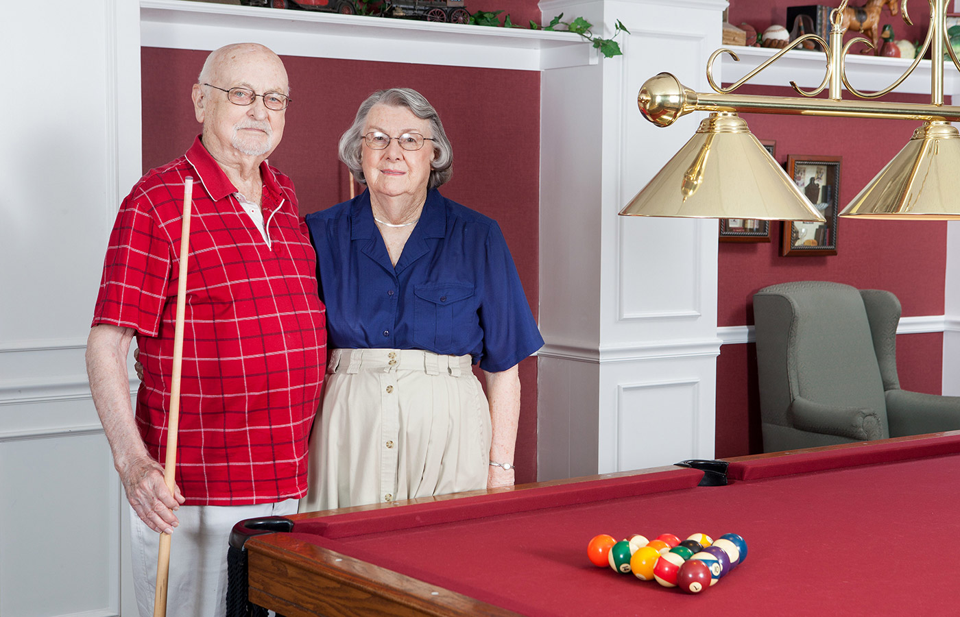Two residents are playing pool.