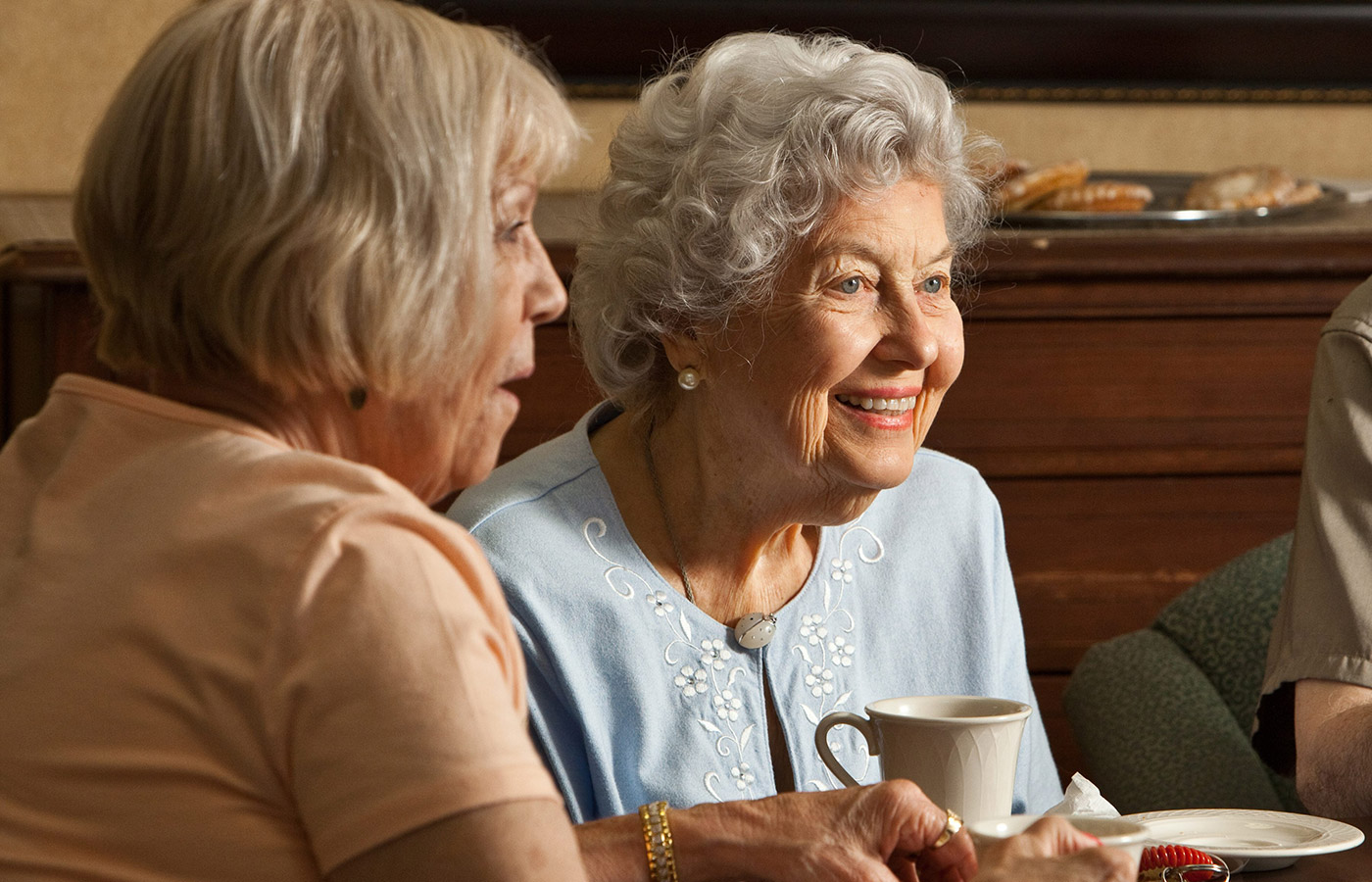 Two residents enjoy a cup of coffee.