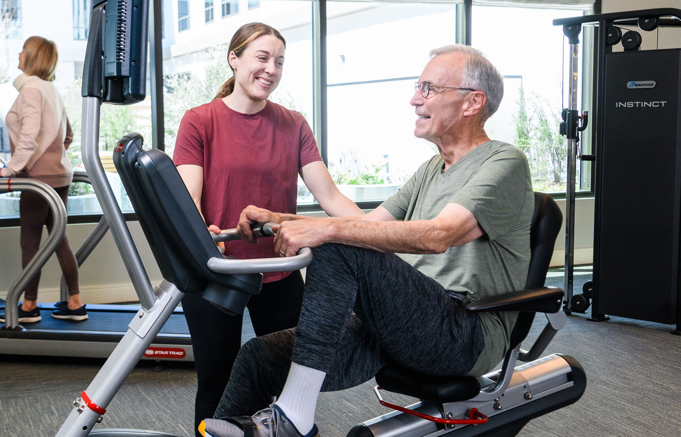 A resident is using a fitness machine.