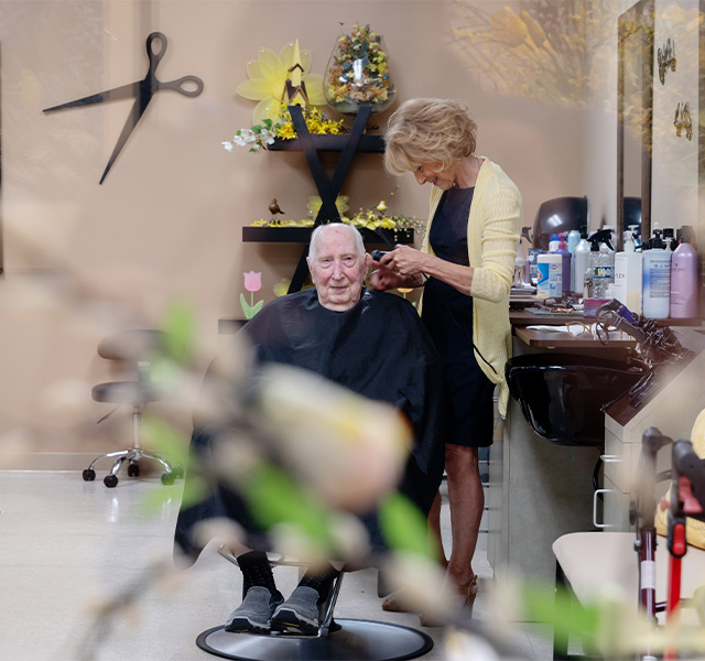 A person getting a haircut in a salon.