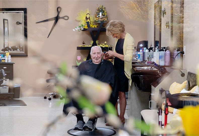 A person getting a haircut at a salon.