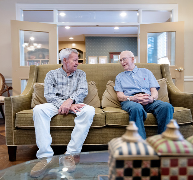 Two people sitting on a couch.
