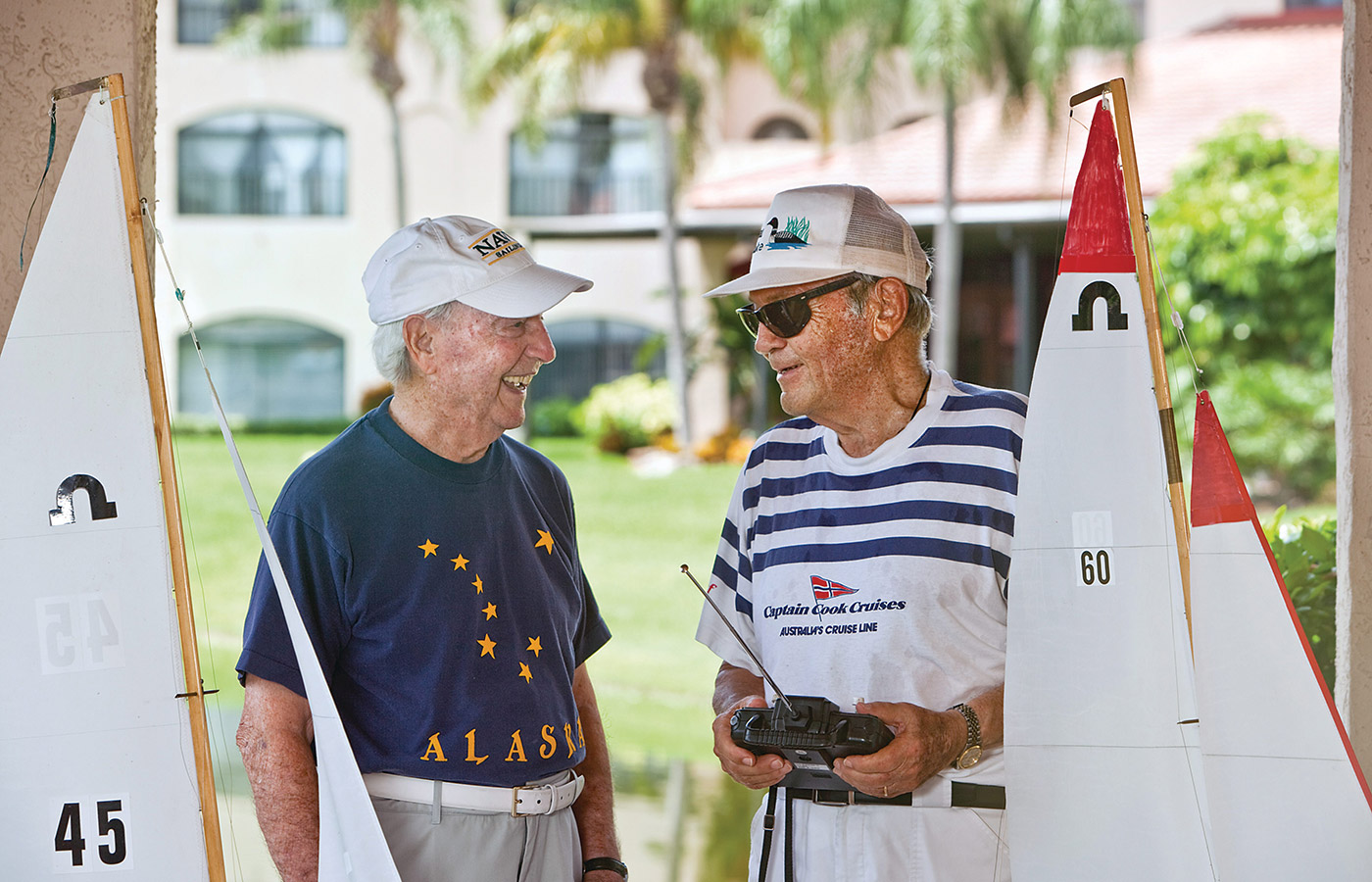 two residents with remote controlled sail boats