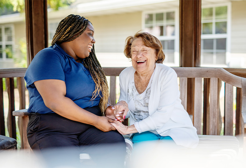 A resident and associate sitting in the gazebo.