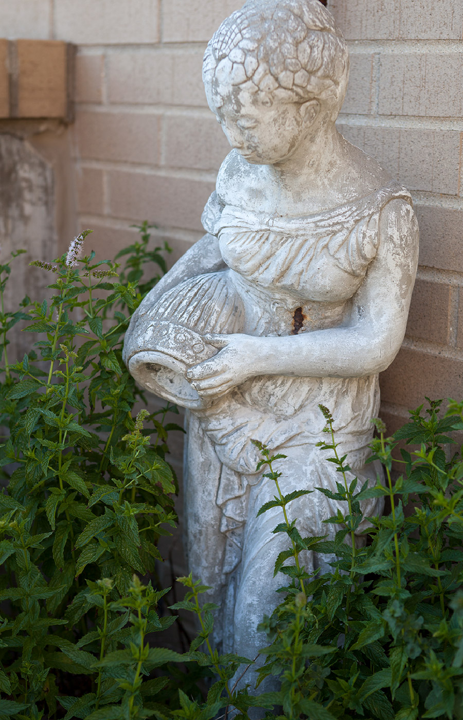 Sculpture of a lady holding a vase