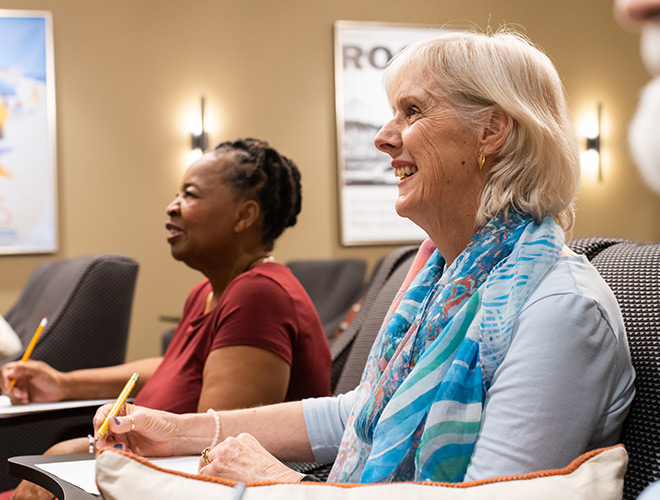 People in a classroom taking notes.