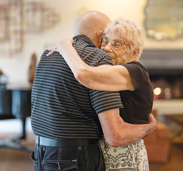 Two residents are dancing together.