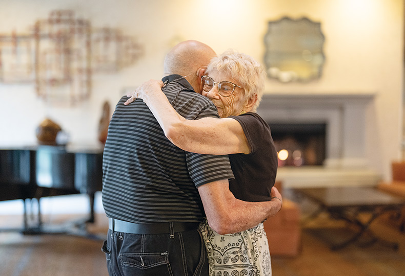 Two residents are dancing together.