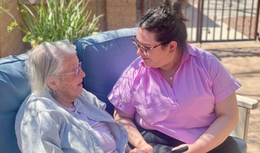 A resident is with an activities assistant at The Fountains at La Cholla.