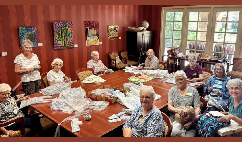 Residents are sitting around a table having a meeting.