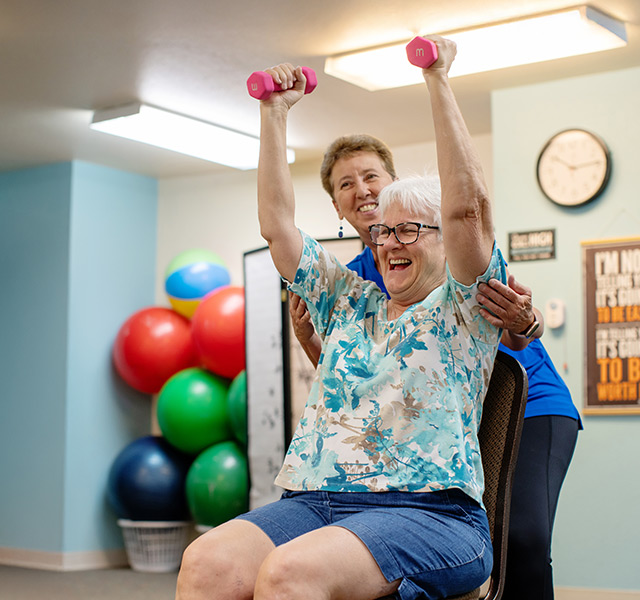 A person in a fitness training session, lifting weights.