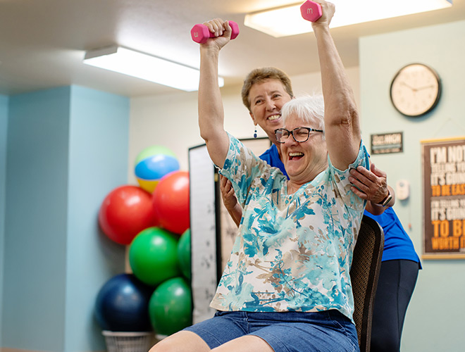A person in a fitness training session, lifting weights.