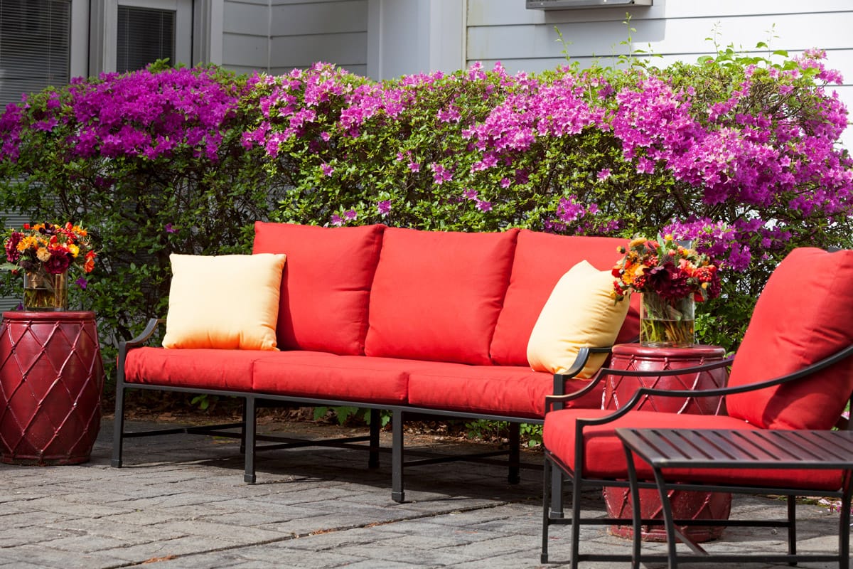 Red patio chairs in courtyard.