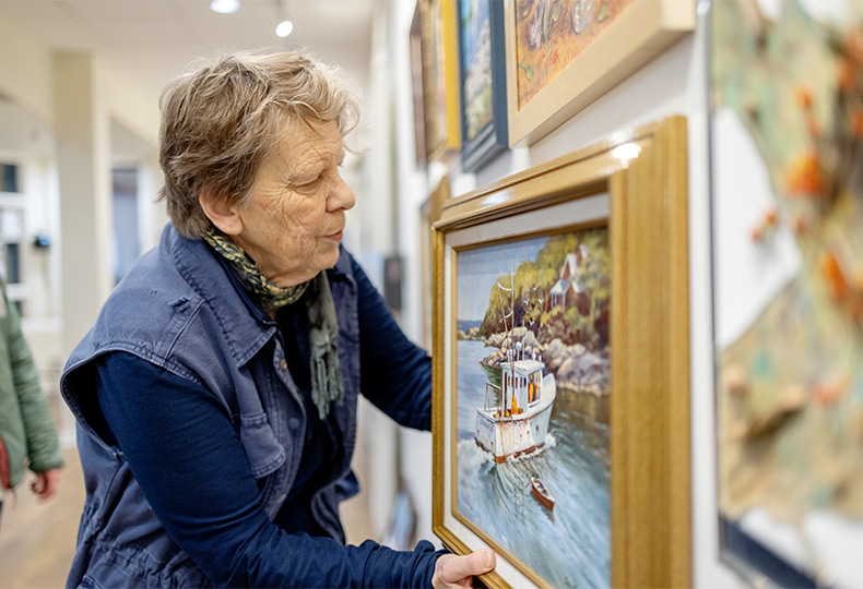 A person hanging a painting.