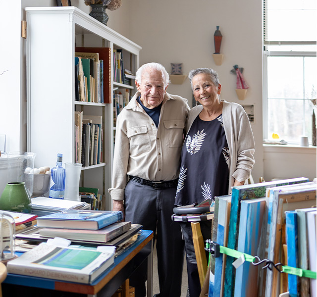 Two people standing in an art studio.