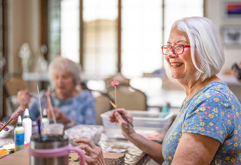 Residents enjoying a painting activity.