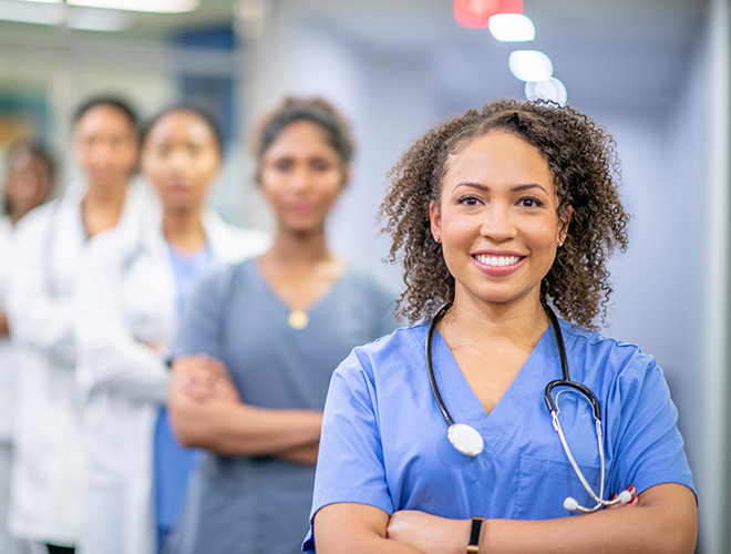 Four nurses smiling.
