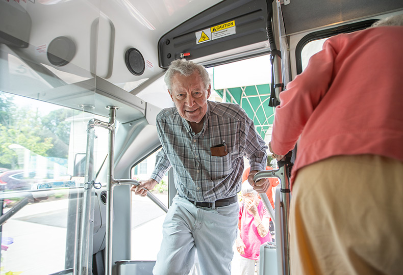 A resident enters a bus.