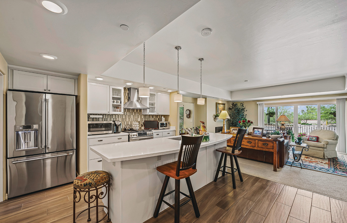 Furnished kitchen with table, cabinets, and refrigerator.