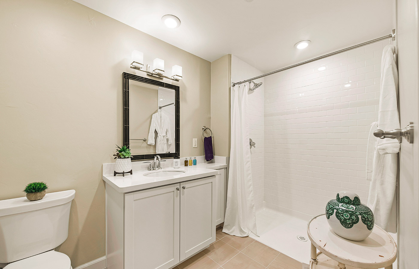 Bathroom with shower, toilet, and sink.