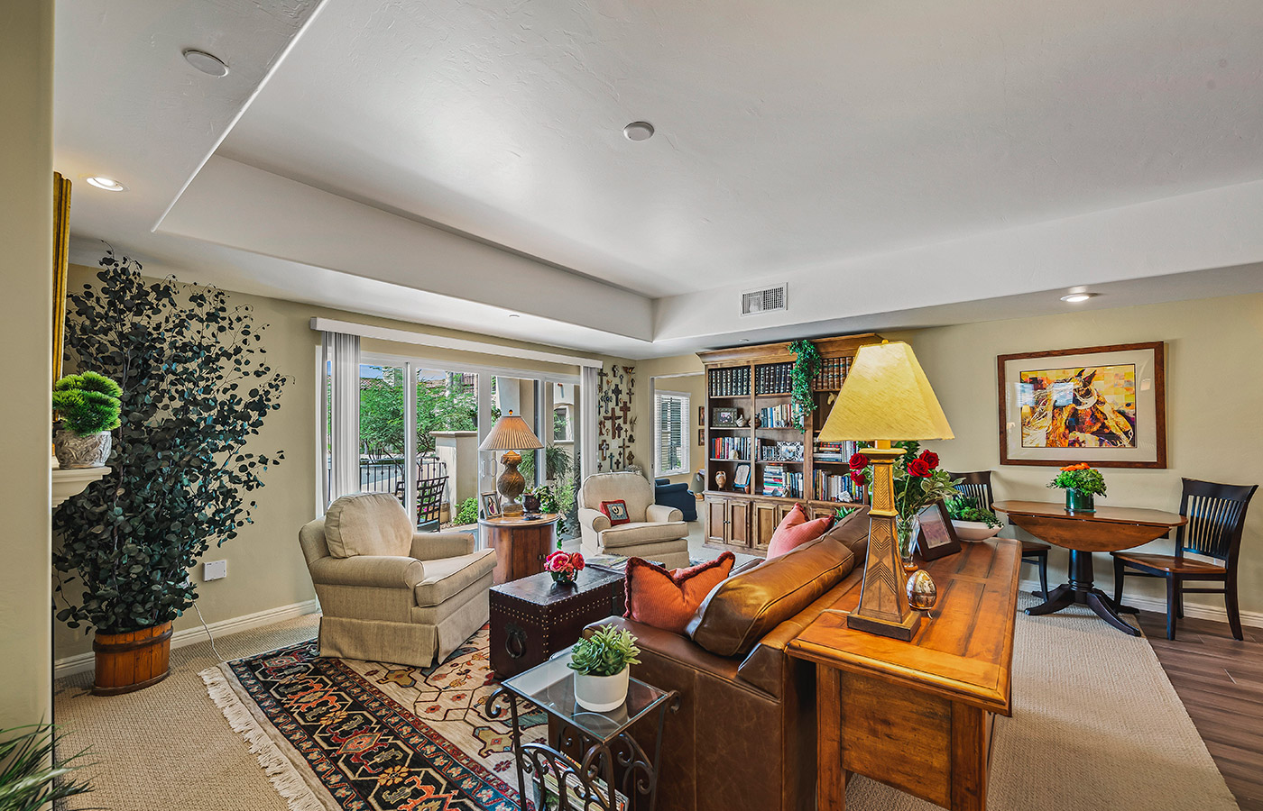 Furnished living room space with sofa, table, and seating area.