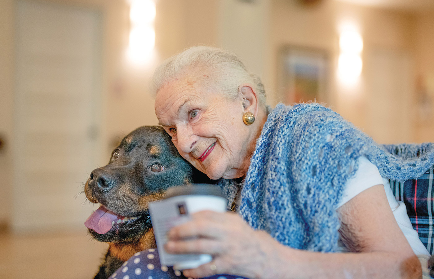 A resident hugging their dog.