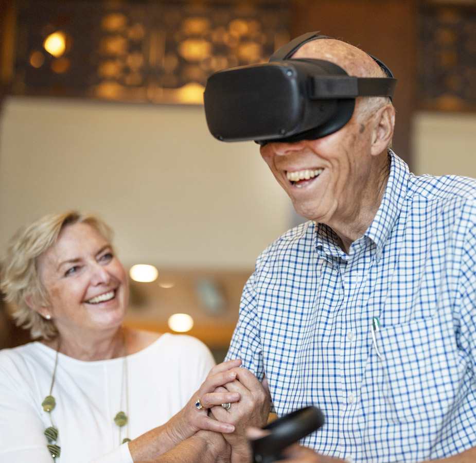 Residents enjoying virtual reality wearing goggles and holding controls.
