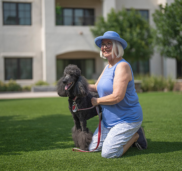 A person outside with their dog.