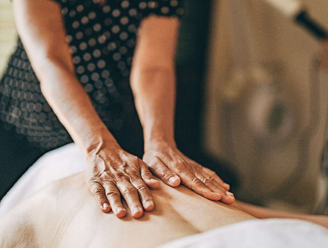 A resident gets massage by masseuse.