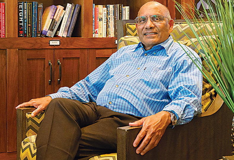 A person is sitting in the library at The Hacienda at the Canyon.