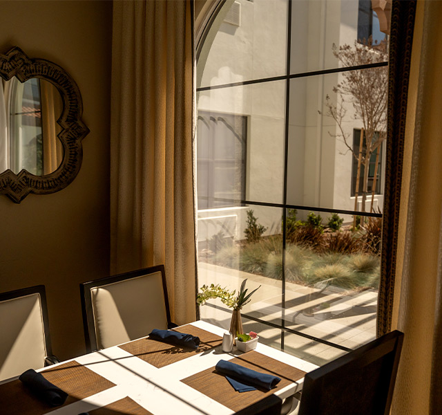 A dining table by a window.