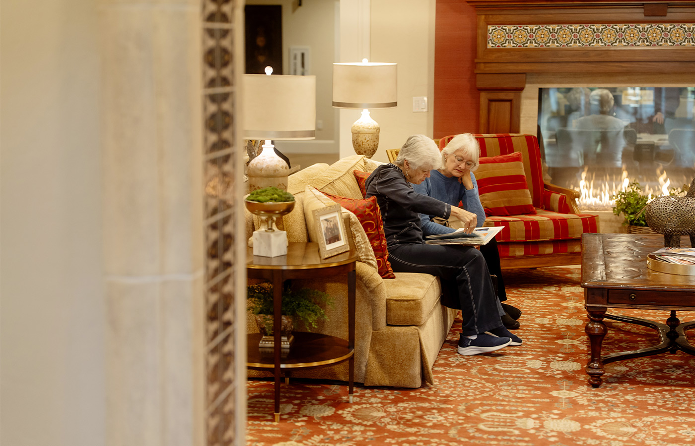 Two people sitting on a couch.
