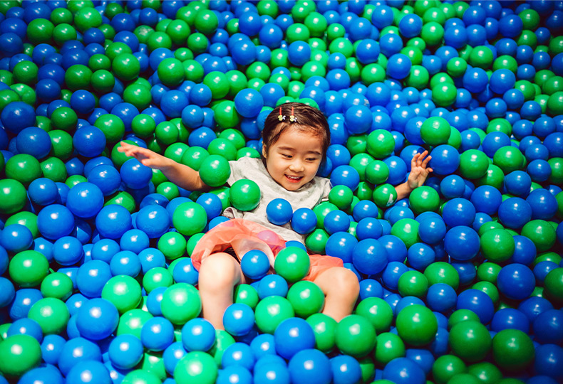 A child in a ball pit.