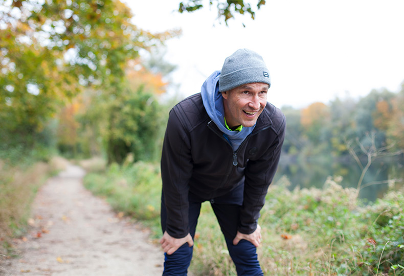 A person resting on a walking trail.