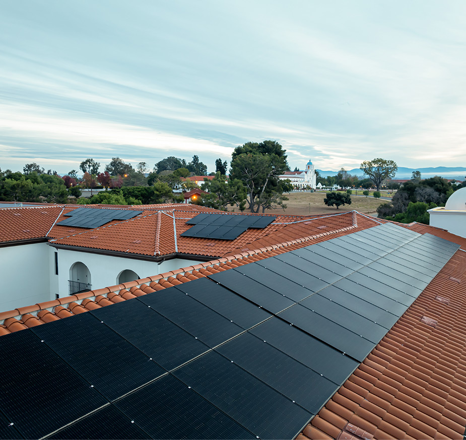 An aerial view of solar panels on a rooftop.