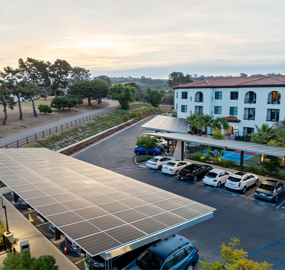 A lot with solar panels over the covered parking.