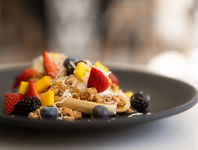 A plate with breakfast food on it.