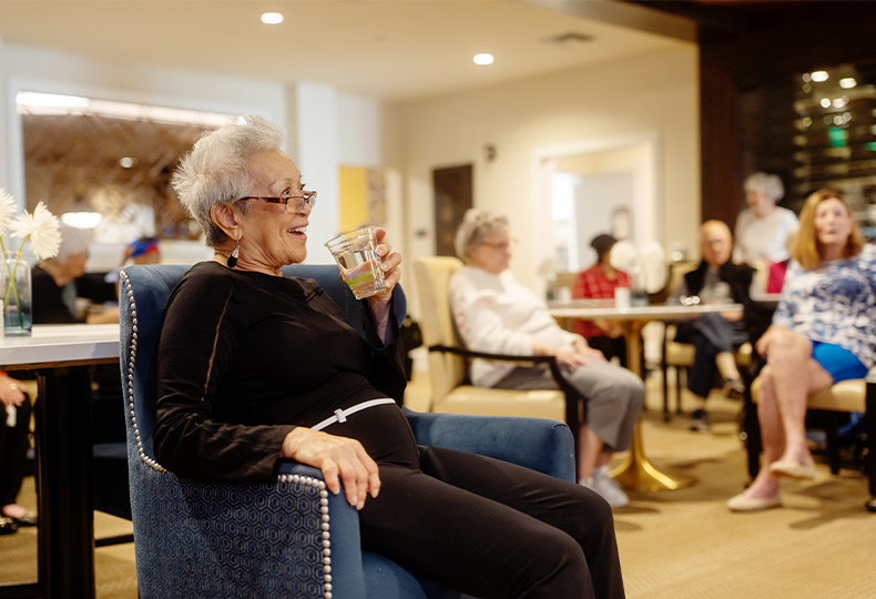 A person sitting with a drink.
