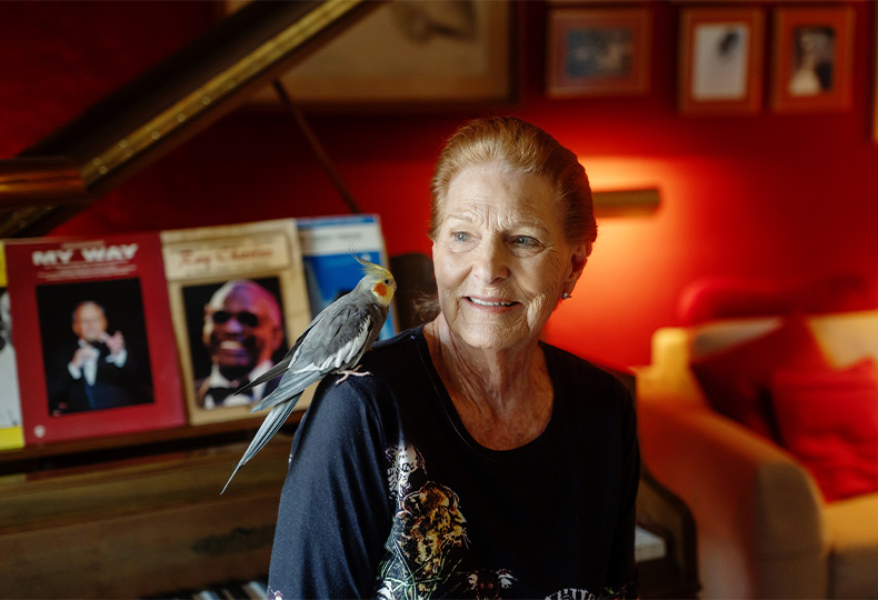 A person with a bird on their shoulder.