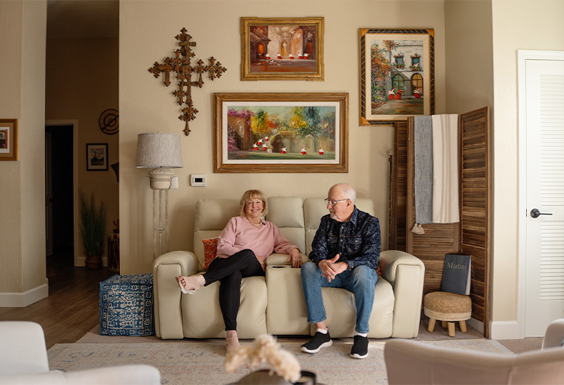 Two people sitting on the couch.
